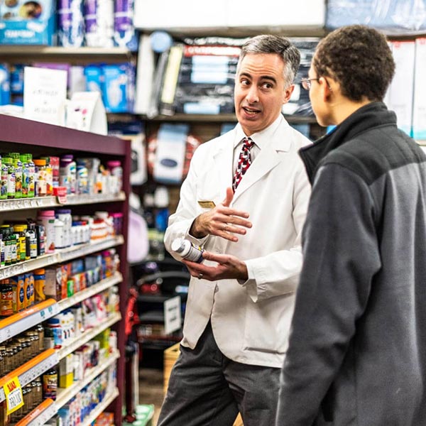 Pharmacist handling customer in shop